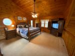 Open Loft Master Bedroom with a king bed, TV and a private screened porch
